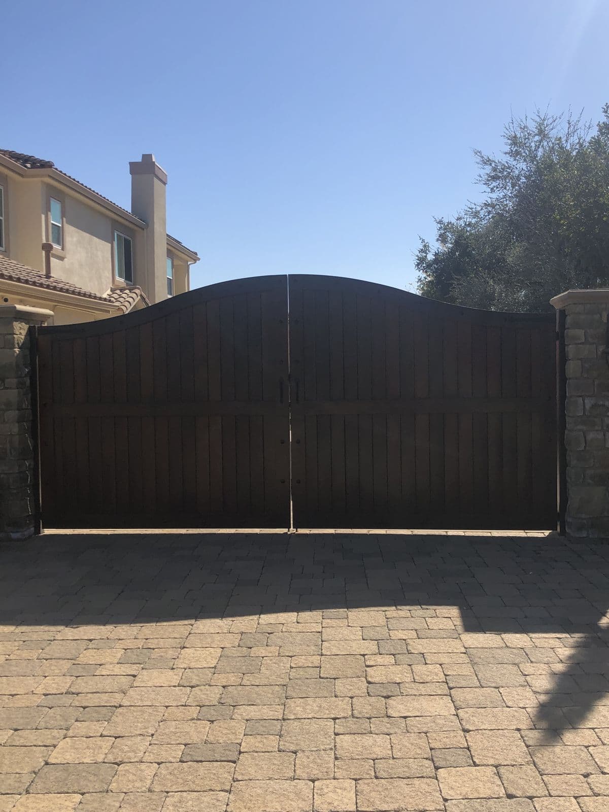 Dark wood arched driveway gate in Simi Valley