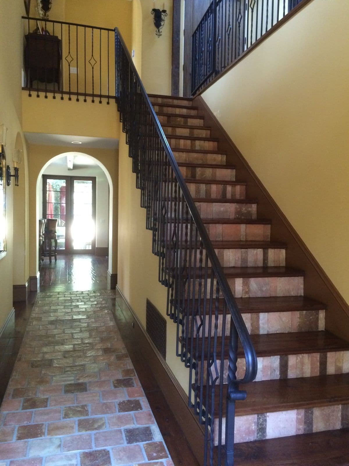 Iron stair railing in tiled entryway