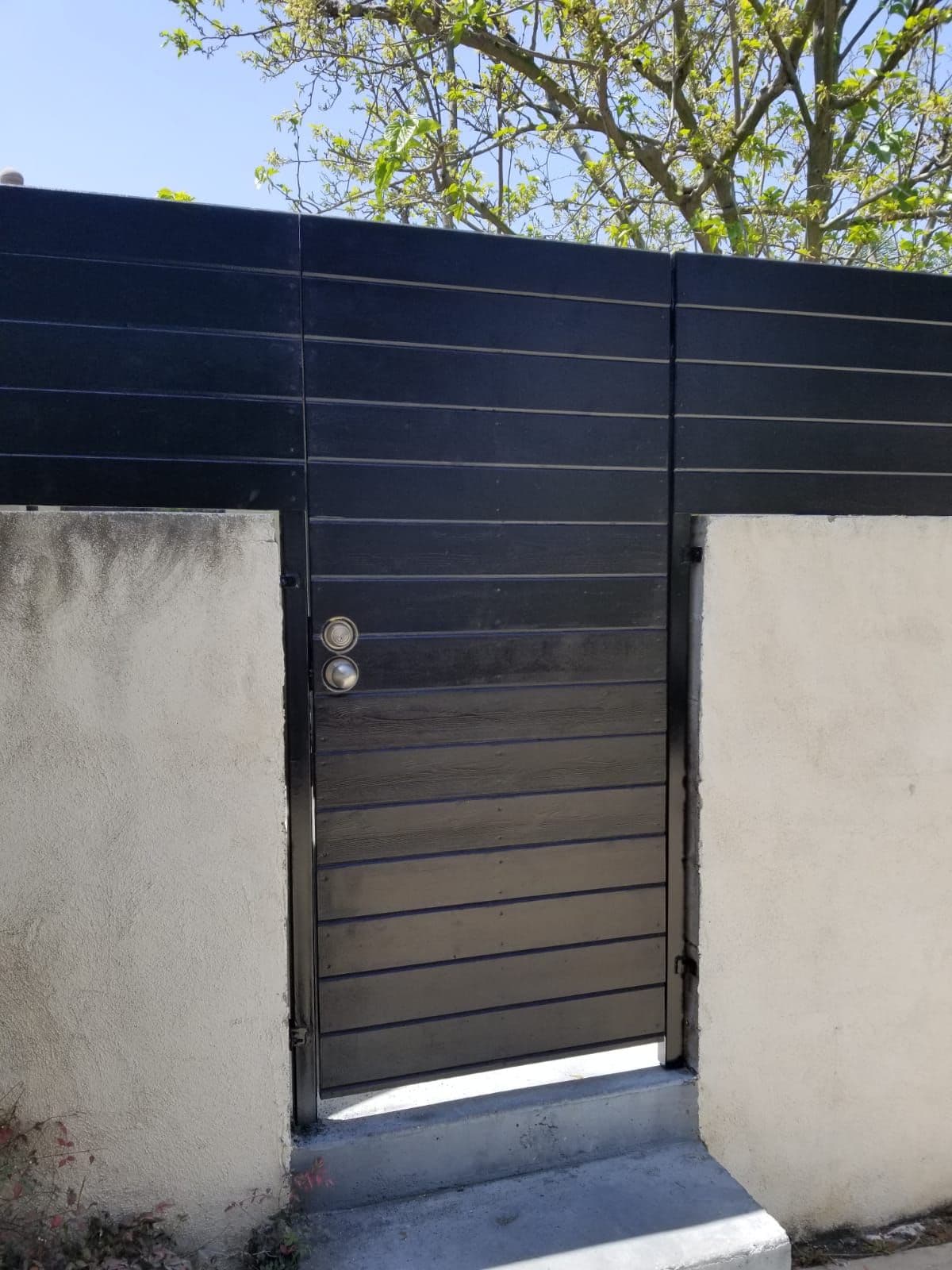 Modern slat pedestrian gate installed by J.V. General Construction