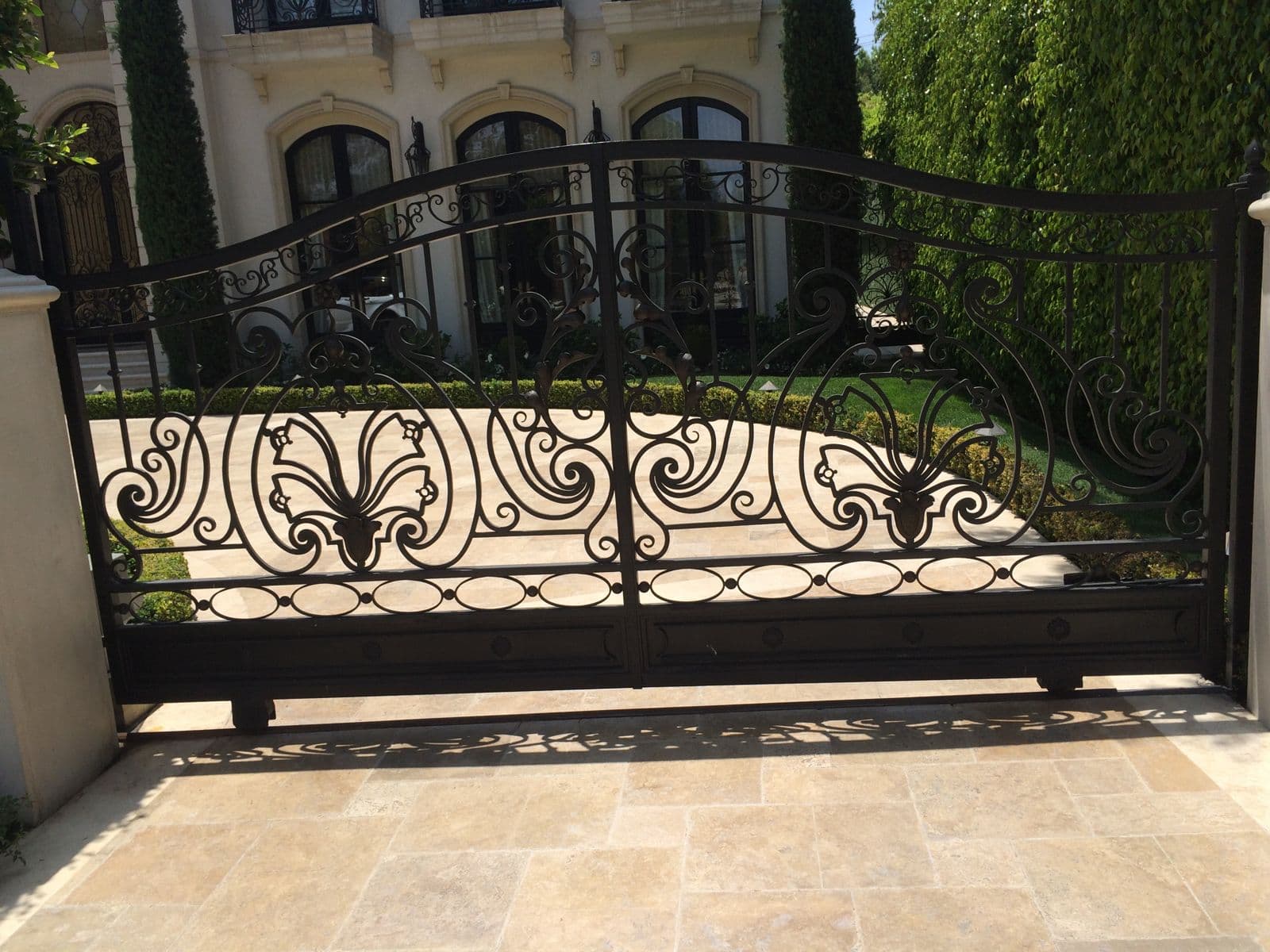 Ornate iron estate fence with decorative leaf pattern