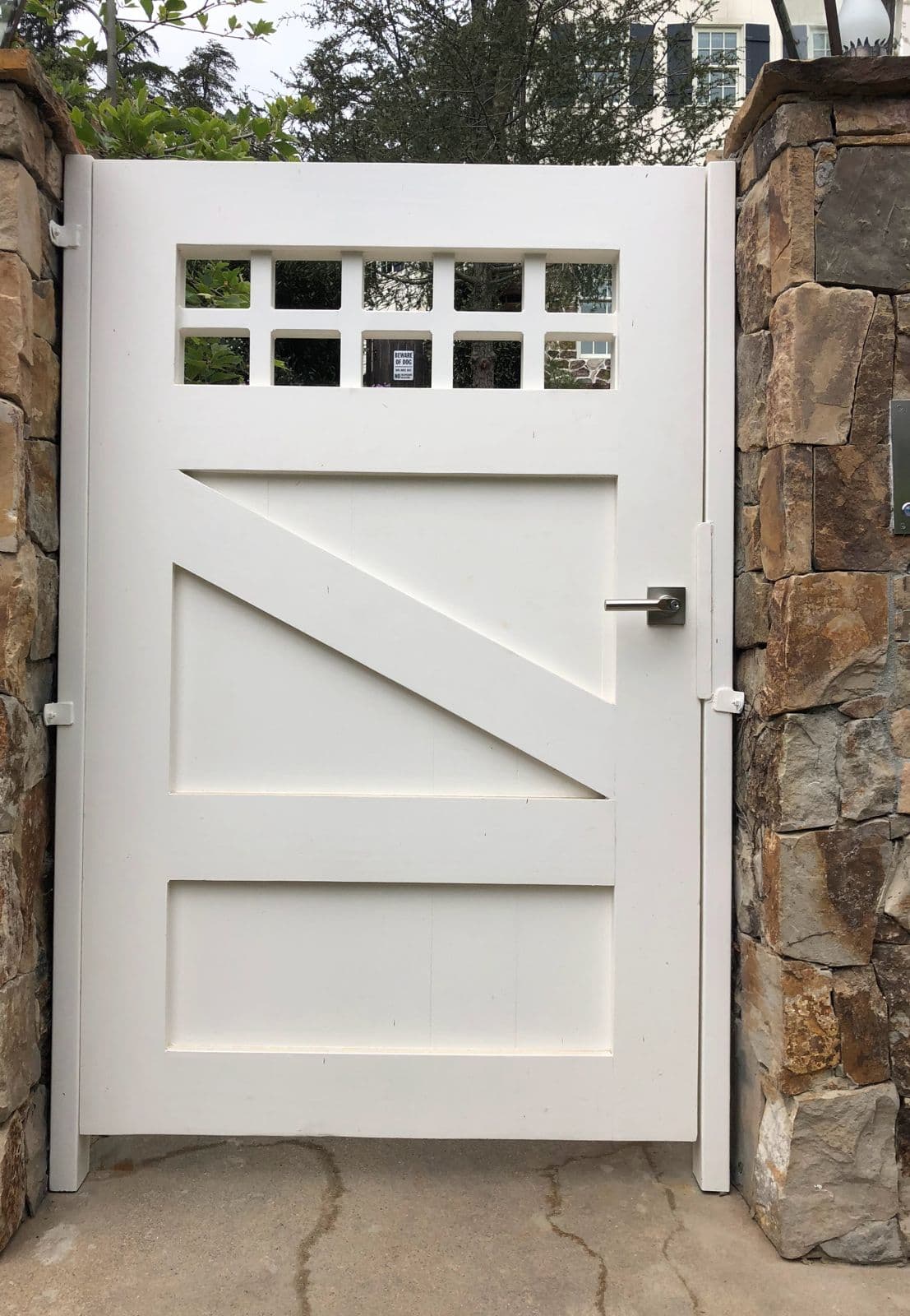 White wood pedestrian gate with window grid